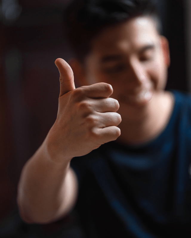 Image of a happy man giving a thumbs up signifying a job well done